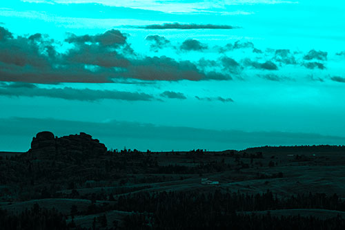 Sunrise Over Rock Formations On The Horizon (Cyan Tone Photo)