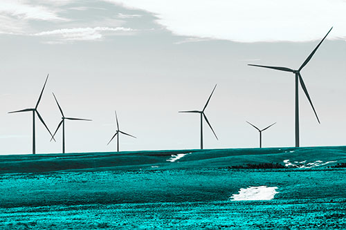 Wind Turbines Scattered Around Melting Snow Patches (Cyan Tone Photo)