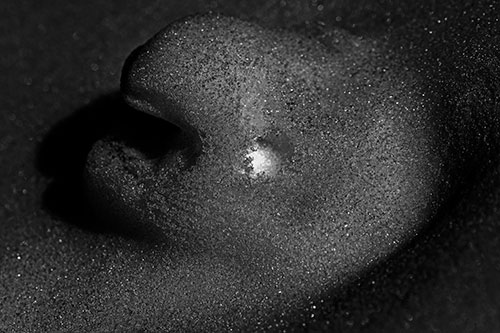 Glowing Eyed Snow Face Emerges Above Soil (Gray)