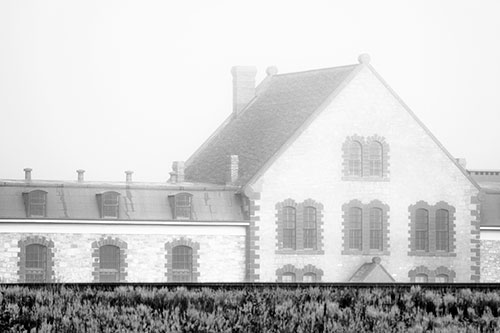 Historic State Penitentiary Oozes Among Fog (Gray Photo)