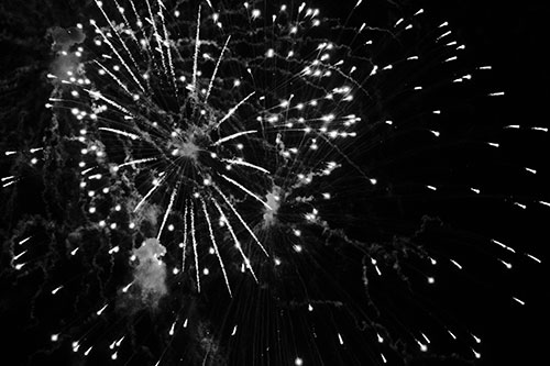 Multiple Firework Explosions Send Light Orbs Flying (Gray Photo)