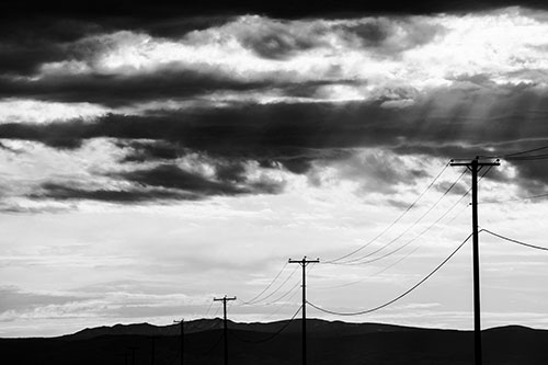 Powerline Silhouette Entering Mountain Range (Gray Photo)