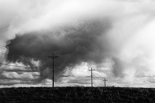 Rainstorm Clouds Twirl Beyond Powerlines (Gray Photo)