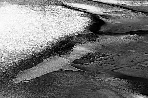 Sloping Ice Melting Atop River Water (Gray Photo)
