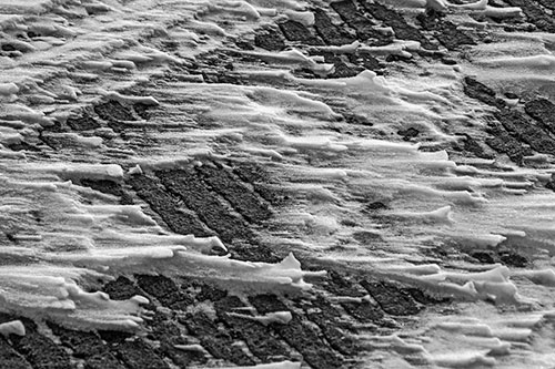 Snow Drifts Atop Rigid Pavement (Gray Photo)