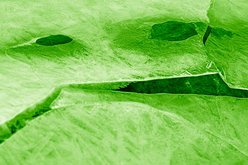 Rock Face Emerges Among Cracked Frozen Ice (Green Shade)