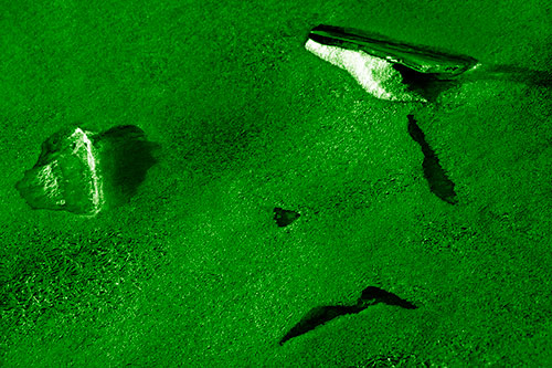 Sad Teardrop Ice Face Appears Atop Frozen River (Green Shade Photo)