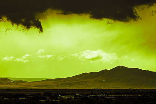 Dark Cloud Mass Above Mountain Range Horizon (Green Tint Photo)