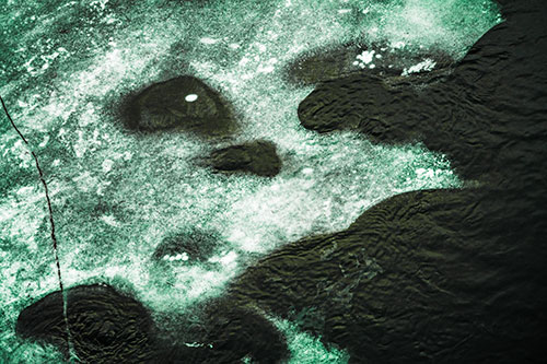 Disintegrating Ice Face Melting Among Flowing River Water (Green Tint Photo)