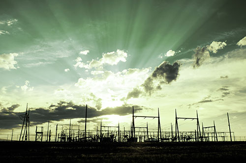 Electrical Substation Sunset Bursting Through Clouds (Green Tint Photo)