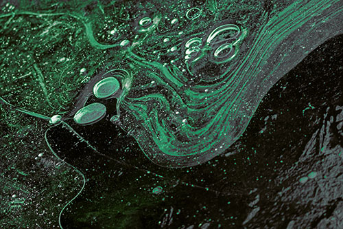 Frozen Bubble Clusters Among Twirling River Ice (Green Tint)