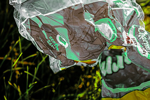 Growling Plastic Charmin Bag Among Grass (Green Tint)