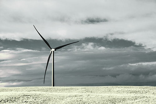 Lone Wind Turbine Standing Along Dry Prairie Horizon (Green Tint Photo)