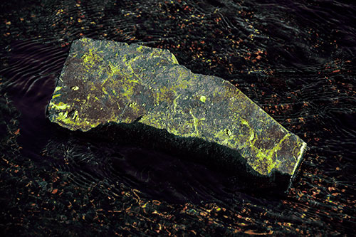 Massive Rock Atop Riverbed (Green Tint Photo)