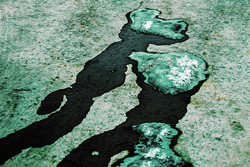 Melting Ice Puddles Forming Water Streams (Green Tint Photo)
