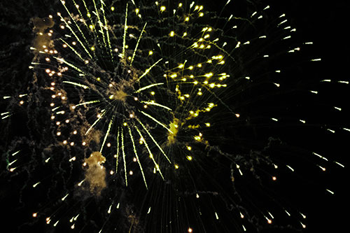 Multiple Firework Explosions Send Light Orbs Flying (Green Tint Photo)