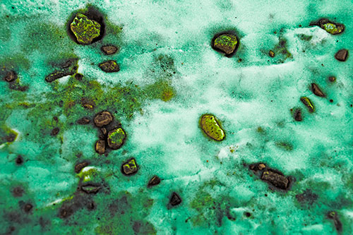 Rocks Forming Smiley Face Atop Snow (Green Tint Photo)