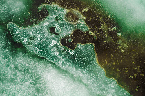 Screaming Submerged Bubble Face Creature Among Icy River (Green Tint Photo)