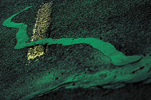 Slithering Tar Creeps Over Pavement Marking (Green Tint Photo)