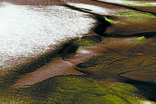 Sloping Ice Melting Atop River Water (Green Tint Photo)