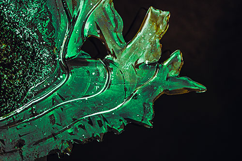 Smooth Ice Face Creature Hanging Above River Shoreline (Green Tint)