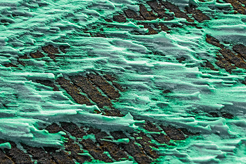 Snow Drifts Atop Rigid Pavement (Green Tint Photo)