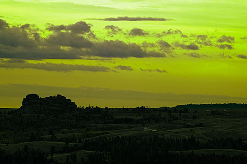 Sunrise Over Rock Formations On The Horizon (Green Tint Photo)