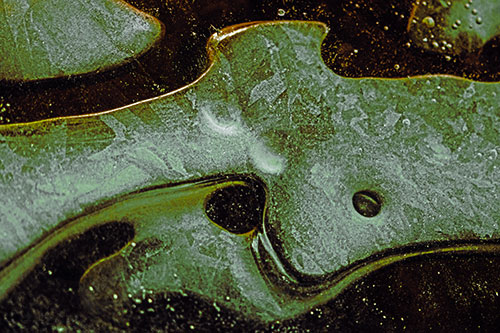 Swirling Frozen Smiling Bubble Eyed River Ice Face (Green Tint)