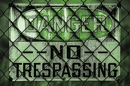Dirty Danger No Trespassing Sign Behind Chain Link Fence (Green Tone)