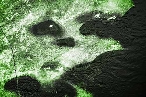 Disintegrating Ice Face Melting Among Flowing River Water (Green Tone)
