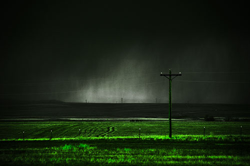 Distant Thunderstorm Rains Down Upon Powerlines (Green Tone Photo)