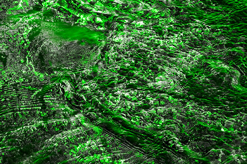 Large Algae Rock Creating River Water Ripples (Green Tone Photo)