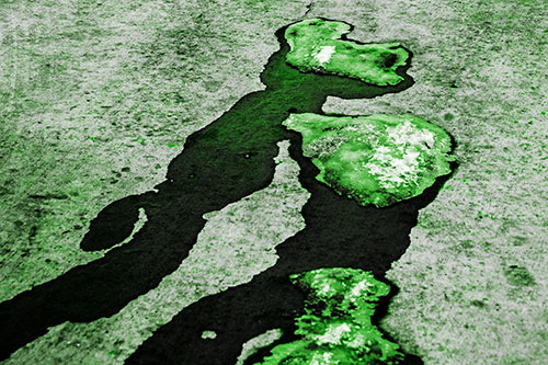 Melting Ice Puddles Forming Water Streams (Green Tone Photo)