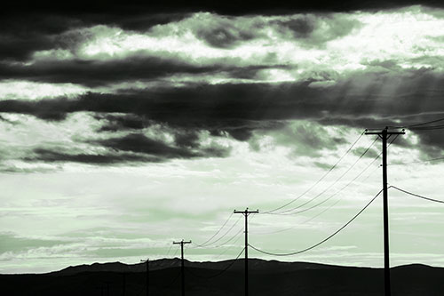 Powerline Silhouette Entering Mountain Range (Green Tone Photo)