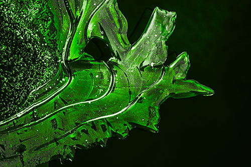 Smooth Ice Face Creature Hanging Above River Shoreline (Green Tone)