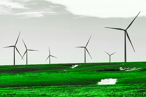 Wind Turbines Scattered Around Melting Snow Patches (Green Tone Photo)