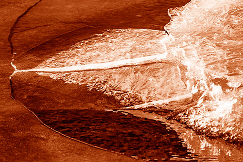 Abstract Ice Sculpture Forms Atop Frozen River (Orange Shade Photo)