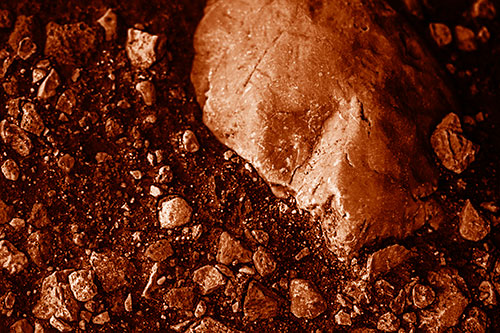 Alien Skull Rock Face Emerging Atop Dirt Surface (Orange Shade Photo)