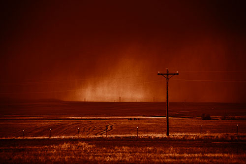 Distant Thunderstorm Rains Down Upon Powerlines (Orange Shade Photo)