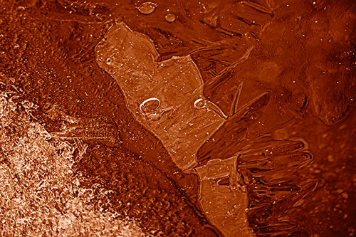 Frozen Bubble Eyed Ice Face Figure Along River Shoreline (Orange Shade)