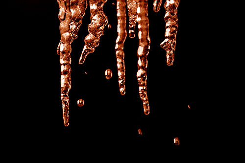 Jagged Melting Icicles Dripping Water (Orange Shade Photo)
