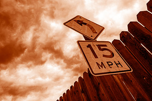 Left Turn Speed Limit Sign Beside Wooden Fence (Orange Shade Photo)