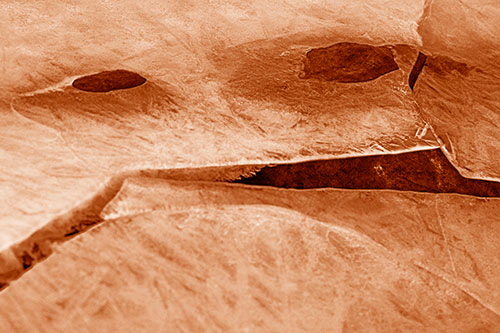 Rock Face Emerges Among Cracked Frozen Ice (Orange Shade)