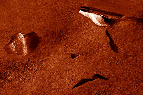 Sad Teardrop Ice Face Appears Atop Frozen River (Orange Shade Photo)