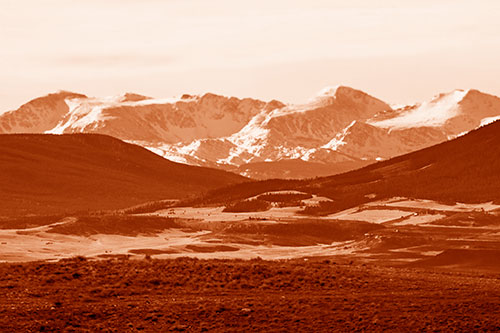 Snow Capped Mountains Behind Hills (Orange Shade Photo)