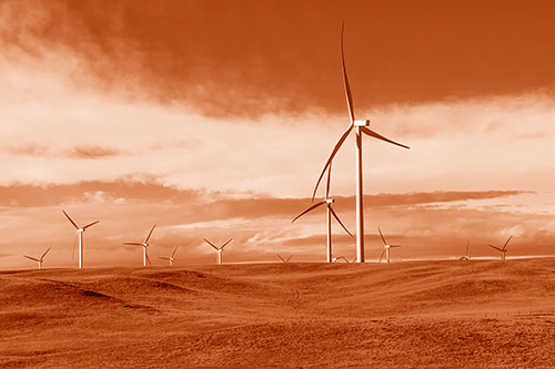 Wind Turbine Cluster Overtaking Hilly Horizon (Orange Shade Photo)