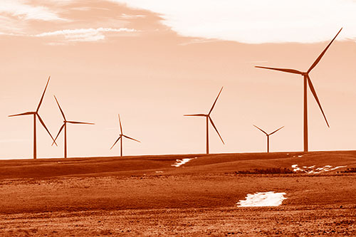 Wind Turbines Scattered Around Melting Snow Patches (Orange Shade Photo)