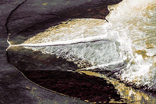 Abstract Ice Sculpture Forms Atop Frozen River (Orange Tint Photo)
