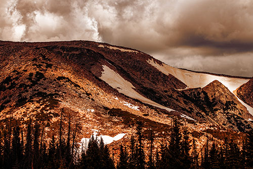 Clouds Cover Melted Snowy Mountain Range (Orange Tint Photo)