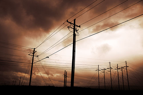 Crossing Powerlines Beneath Rainstorm (Orange Tint Photo)